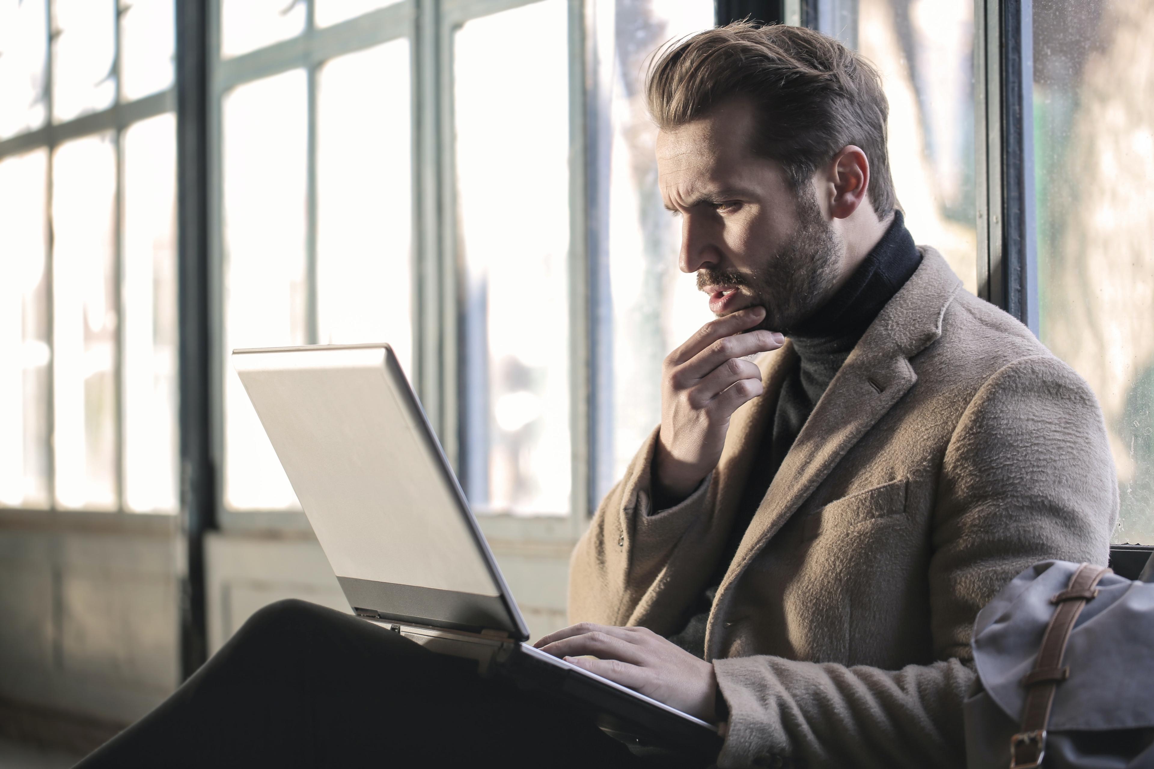 men thinking in front of computer